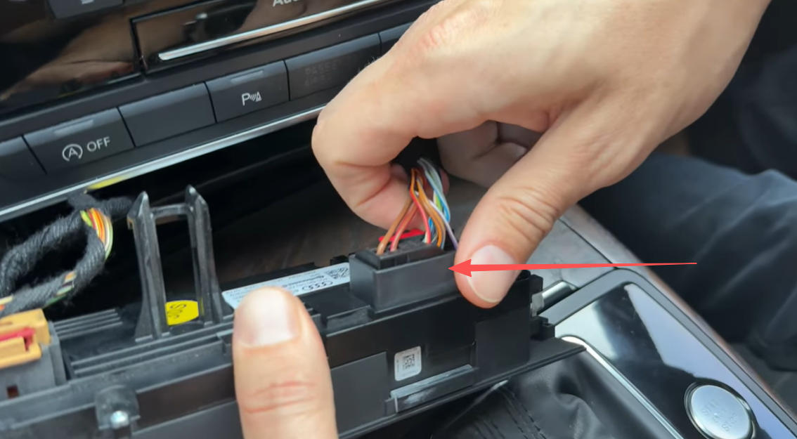 Den Stecker hinter der Klimaanlagenverkleidung des A6 entfernen.